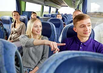Two passengers ride a bus